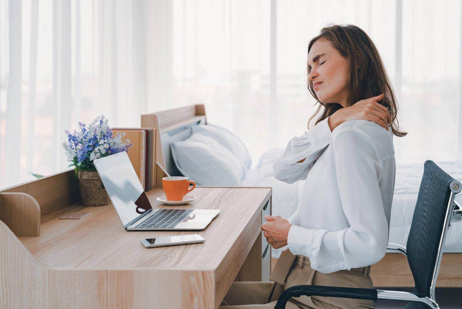 A woman massaging her shoulder that has been injured by a repetitive stress injury related to work in Forest Park, Georgia